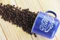 Natural black coffee beans and ceramic blue a mug Royalty Free Stock Photo