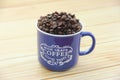 Natural black coffee beans and ceramic blue a mug Royalty Free Stock Photo
