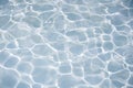 Natural blue water surface with bright sun light reflections. water in swimming pool background Royalty Free Stock Photo