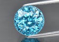 Natural blue zircon gemstone on gray background Royalty Free Stock Photo
