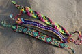 Natural bracelets of friendship in a row, colorful woven friendship bracelets, background, rainbow colors, checkered pattern
