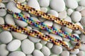 Natural bracelets of friendship in a row, colorful woven friendship bracelets, snow background, rainbow colors, checkered pattern