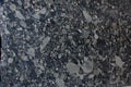 Natural Brazilian granite with pebbles of black and gray shades of color frozen in it is called Nero Marinace