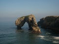 Natural bridge arch El Castro de las Gaviotas Islote Desfuracado at Playa de la Huelga beach Hontoria Asturias Spain