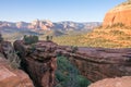 Natural bridge in front of valley view in arizona desert