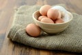 Natural brown eggs in a bamboo cup on burlap sack Royalty Free Stock Photo