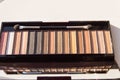 Natural brown Nude eyeshadow palette close-up, with tassel on white background