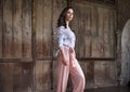 Natural brunette lady posing in front of the wooden gate