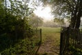 Entrance gate in fence towards green natural camp ground