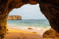 Natural cave in the Algarve on the beach at Praia da Coelha, Albufeira, Portugal Royalty Free Stock Photo