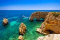 Natural caves at Marinha beach, Algarve Portugal. Rock cliff arches on Marinha beach and turquoise sea water on coast of Portugal Royalty Free Stock Photo