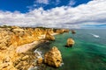 Natural caves at Marinha beach, Algarve Portugal. Rock cliff arches on Marinha beach and turquoise sea water on coast of Portugal Royalty Free Stock Photo