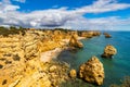 Natural caves at Marinha beach, Algarve Portugal. Rock cliff arches on Marinha beach and turquoise sea water on coast of Portugal Royalty Free Stock Photo