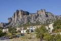 natural caves for monks in the rock formations of Meteora above the Greek white houses of Kastraki, Kalabaka, Greece Royalty Free Stock Photo