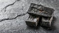 Natural Charcoal Pieces on Slate Surface Showing Rustic Texture with Dramatic Lighting and Rich Details in a High Resolution Royalty Free Stock Photo