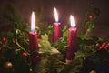 Three red Christmas candles in a festive traditional table decoration Royalty Free Stock Photo