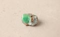 Natural chrysoprase stone lies is on a light background. Natural stones, crystals for magic, lithotherapy, geology, minerals,