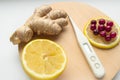 Natural cold remedies on a round WOODEN TRAY, ginger, cranberries, thermometer