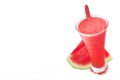 Natural cold watermelon juice against a white background next to some fruit slices. Smoothie and empty copy space Royalty Free Stock Photo