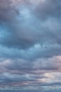 Natural color dramatic dark blue cloudy sky with wavy rippling clouds aligned above horizon, taken with wide angle 35 mm lens Royalty Free Stock Photo