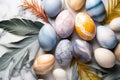 Natural colorant painted eggs with marble effect on table with tropical leaves, happy Easter celebration concept.