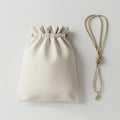 A natural-colored, linen drawstring bag is displayed on a light surface. It appears slightly Royalty Free Stock Photo