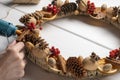 Natural components wreath. Woman`s hands making natural eco Christmas decoration