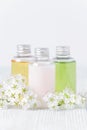 Natural cosmetic bottles with fresh flowers, toiletries, hygiene products Royalty Free Stock Photo