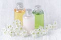 Natural cosmetic bottles with fresh flowers, white, green and yellow Royalty Free Stock Photo