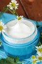 Natural cosmetic cream lotion with camomile Royalty Free Stock Photo