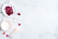 Natural cosmetic cream and lotion on marble background with red flower petals. Beauty organic product. Top view, flat lay, copy Royalty Free Stock Photo