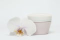 Natural cosmetic face cream in a jar and orchid Royalty Free Stock Photo