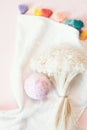 Natural cosmetics. Bath bomb, flowers and towel on pink pastel background Royalty Free Stock Photo