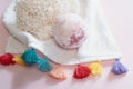 Natural cosmetics. Bath bomb, flowers and towel on pink pastel background Royalty Free Stock Photo