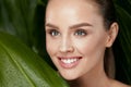 Natural Cosmetics. Beautiful Woman Face With Green Plant