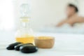 Natural cosmetics and concept. Close up of salt with massage oil and bath towel on Spa bed. Bottle of massage oil, hot stone spa Royalty Free Stock Photo