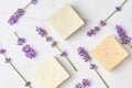 Natural cosmetics concept. pattern of lavender flowers and bars of soap on a marble background. flat lay, top view