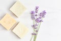 natural cosmetics concept. stack of handmade soap, mini lavender bouquet on marble background.