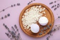 Natural cosmetics. Handmade lavender bath bombs and lavender flowers on wooden board on purple background Royalty Free Stock Photo