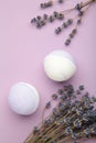 Natural cosmetics. Handmade lavender bath bombs and lavender flowers on purple background Royalty Free Stock Photo