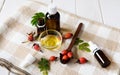 natural cosmetics, natural eco product, composition glass bottles with rosehip oil, rosehips on a light wooden table