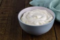 Natural creamy Greek yoghurt on wooden table background with spa