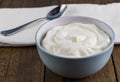 Natural creamy Greek yoghurt on wooden table background