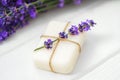 Natural cube of lavender soap on white wooden background