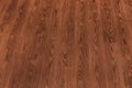 Natural dark brown wooden surface floor texture background.  polished  laminate  parquet Royalty Free Stock Photo