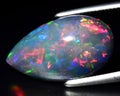 natural dark multicolor rainbow opal gem on the background Royalty Free Stock Photo