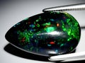 natural dark rainbow opal gem on the background Royalty Free Stock Photo