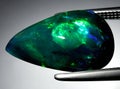 natural dark rainbow opal gem on the background Royalty Free Stock Photo