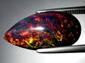 natural dark rainbow opal gem on the background Royalty Free Stock Photo