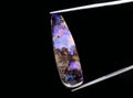 natural dark rainbow opal gem on the background Royalty Free Stock Photo